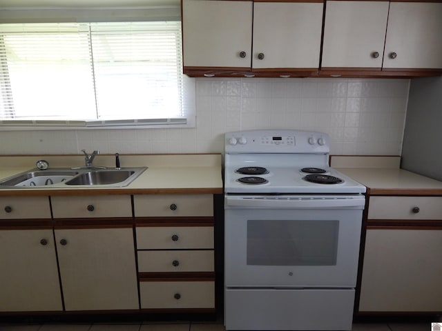 kitchen featuring tile floors, tile walls, sink, and white electric range oven