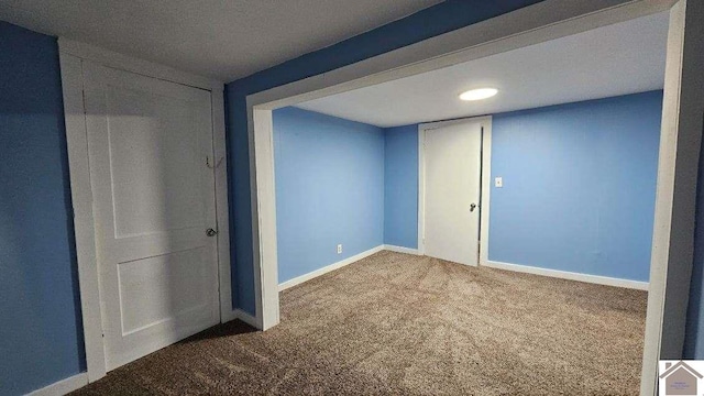 interior space featuring carpet floors and baseboards
