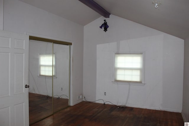 unfurnished bedroom featuring vaulted ceiling with beams, a closet, and dark hardwood / wood-style floors