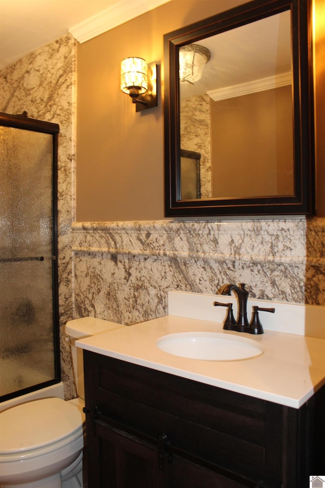 bathroom with vanity, ornamental molding, tile walls, and toilet