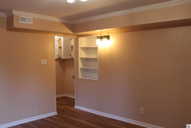 empty room with crown molding and dark wood-type flooring