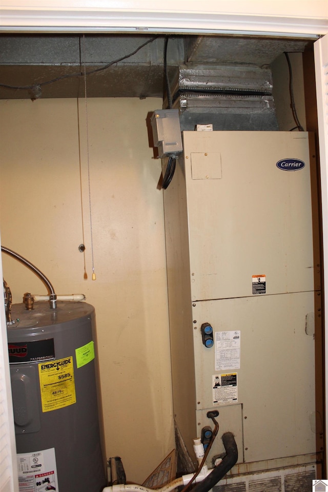 utility room featuring heating unit and water heater