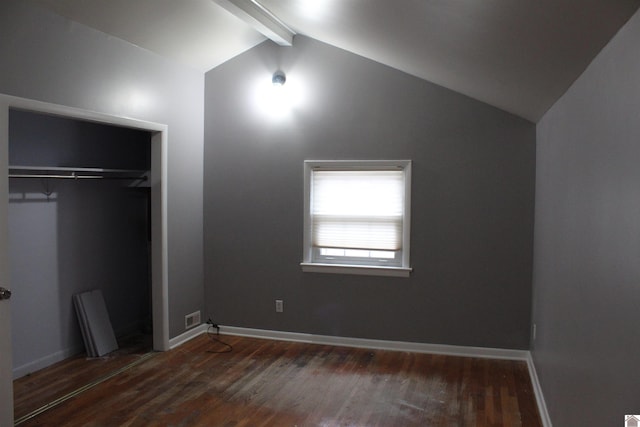 unfurnished bedroom with vaulted ceiling with beams, dark hardwood / wood-style flooring, and a closet