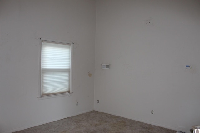 spare room with light carpet