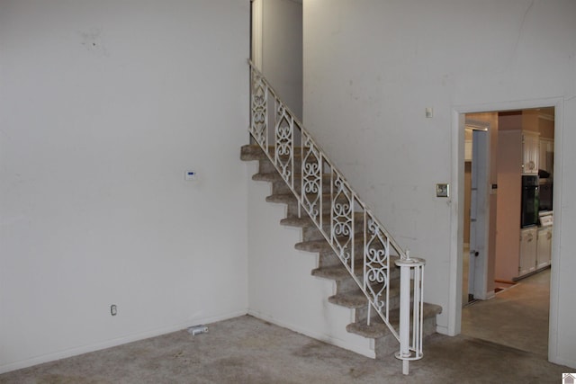 staircase featuring carpet