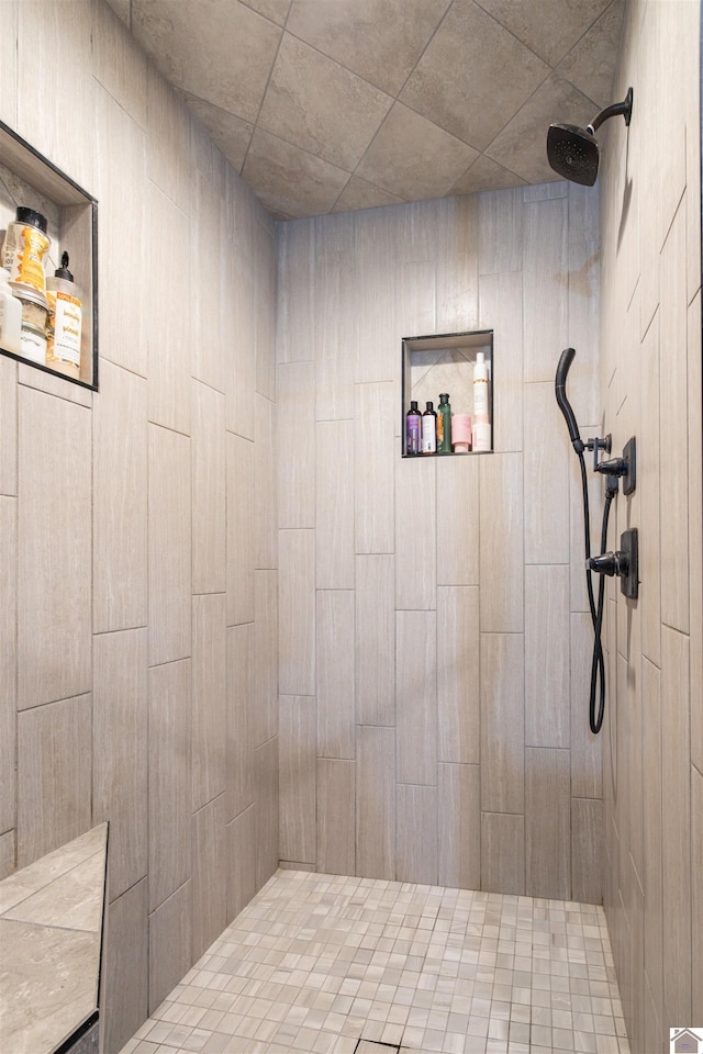 bathroom with a tile shower