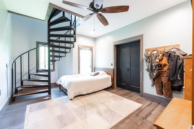 bedroom with wood-type flooring, ceiling fan, and lofted ceiling