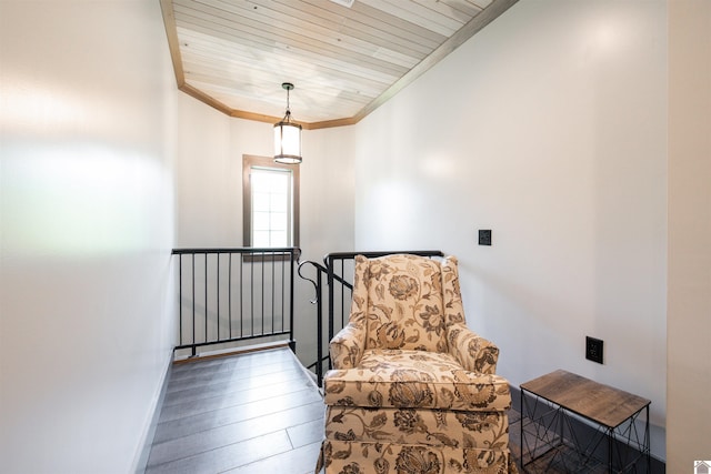 living area with wooden ceiling, hardwood / wood-style floors, and crown molding