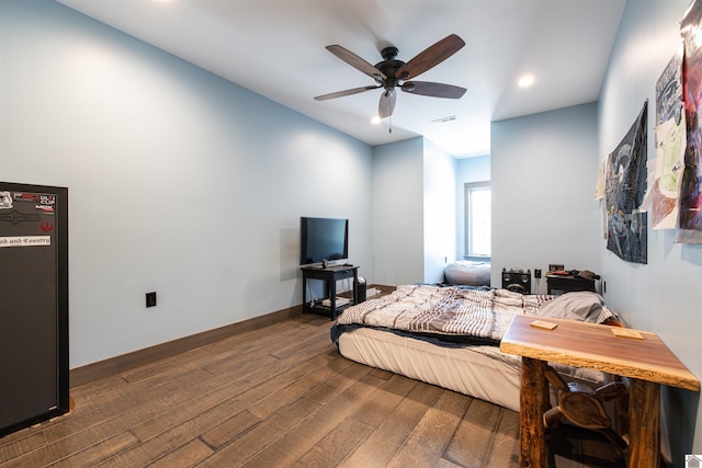 bedroom featuring ceiling fan and dark hardwood / wood-style floors