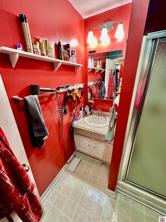 bathroom featuring vanity and an enclosed shower