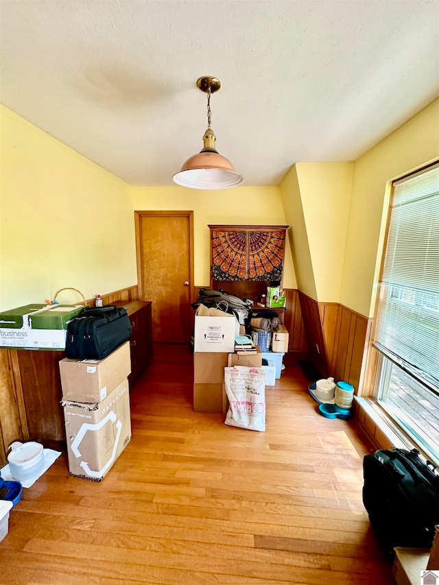 dining space featuring light hardwood / wood-style floors and wooden walls