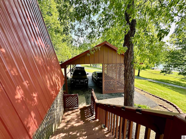 deck with a yard and a carport