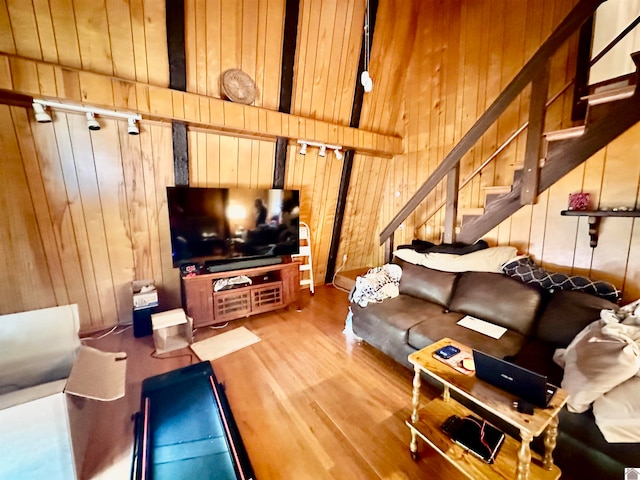 living room featuring hardwood / wood-style floors and wood walls