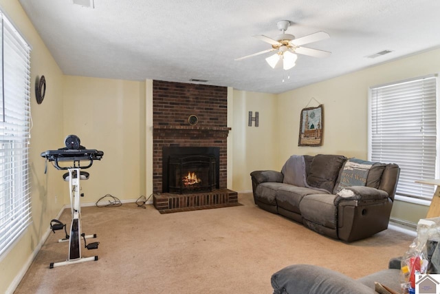 living room with brick wall, ceiling fan, carpet, and a fireplace