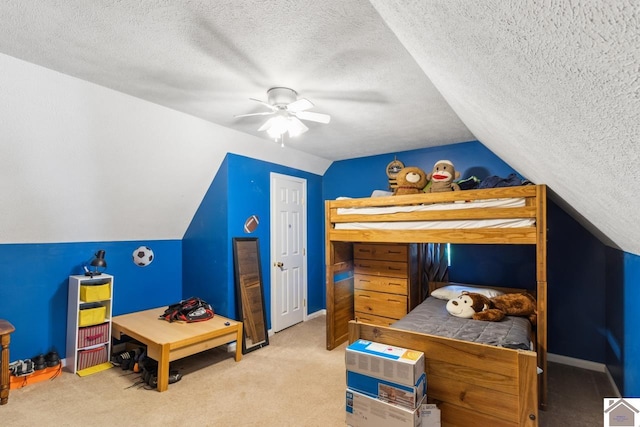 carpeted bedroom featuring a textured ceiling, ceiling fan, and vaulted ceiling