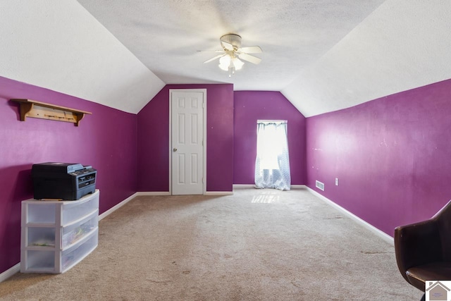 additional living space with ceiling fan, carpet floors, and a textured ceiling