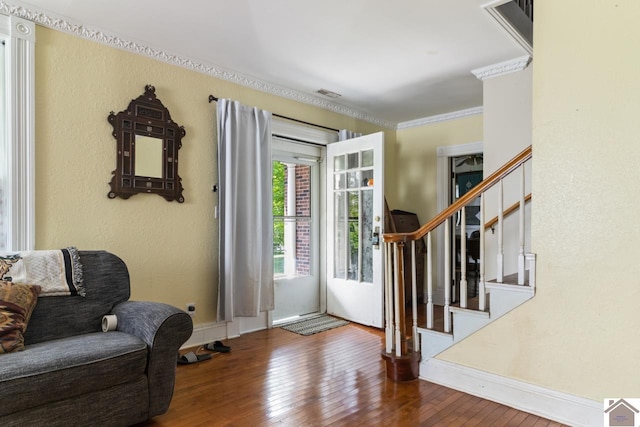 foyer with dark hardwood / wood-style flooring and crown molding