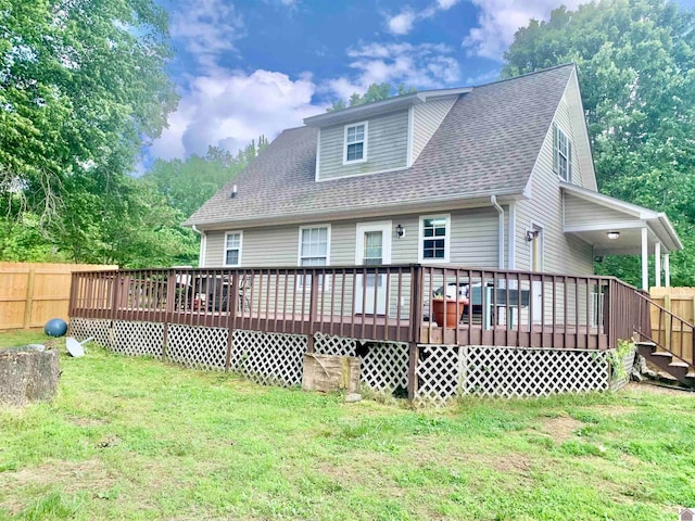 back of house featuring a deck and a yard