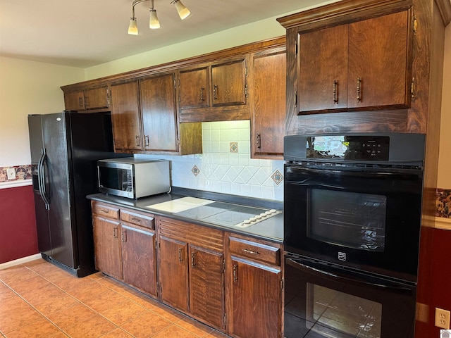 kitchen featuring tasteful backsplash, light tile floors, and black appliances