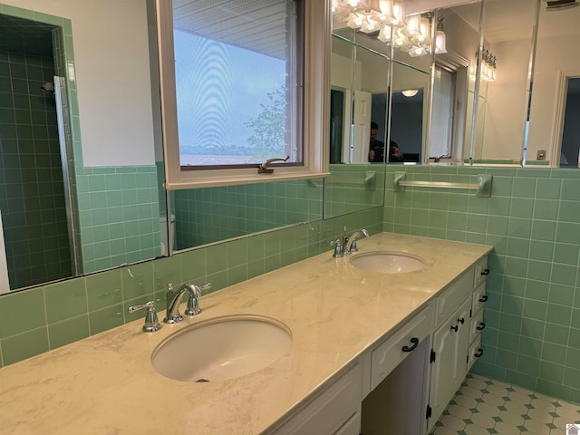 bathroom featuring tile walls, backsplash, dual bowl vanity, and tile floors