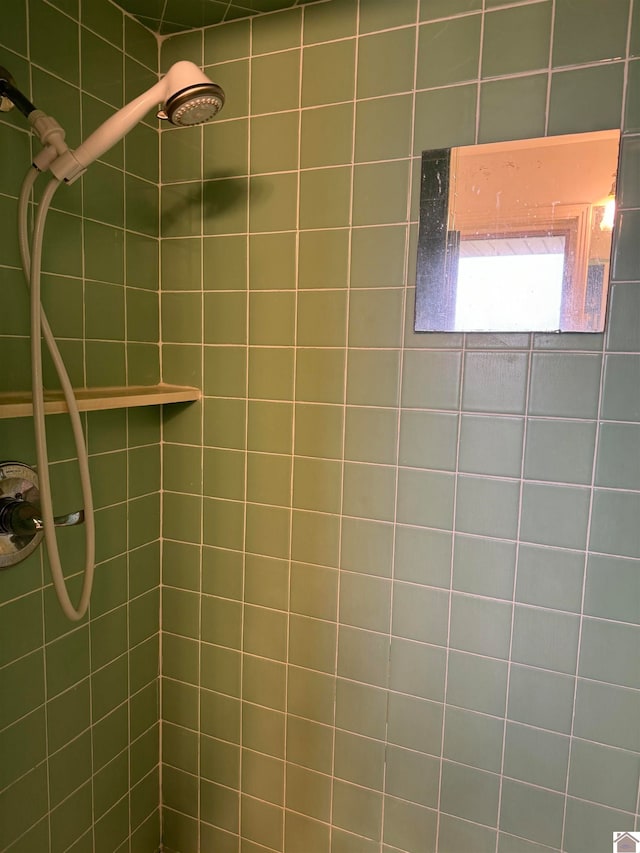 bathroom with tiled shower