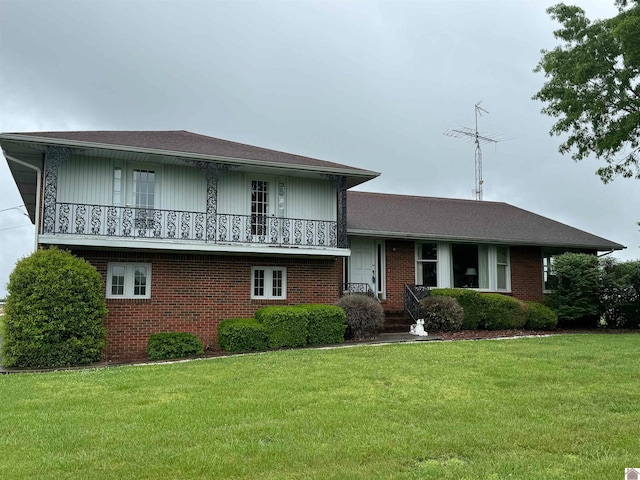 split level home with a balcony and a front yard