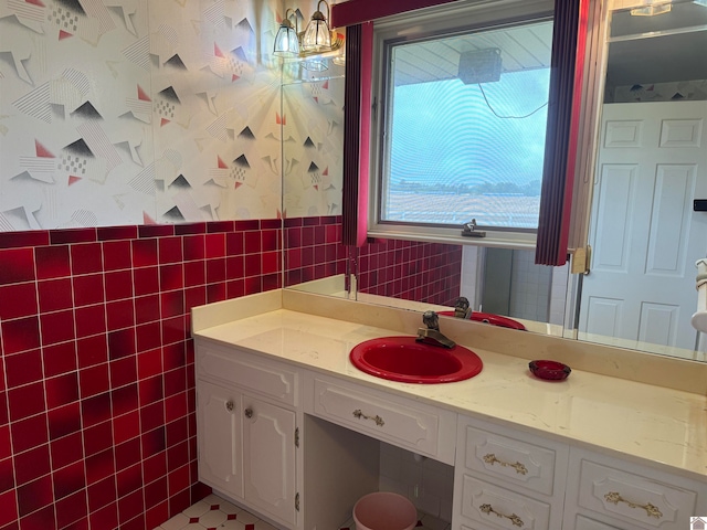 bathroom with vanity, tile floors, and tile walls