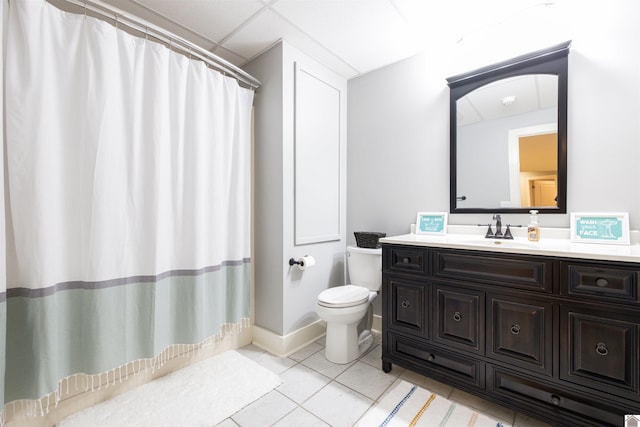 bathroom featuring tile floors, vanity, and toilet