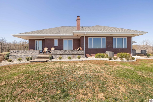 view of front of property featuring central AC and a front lawn