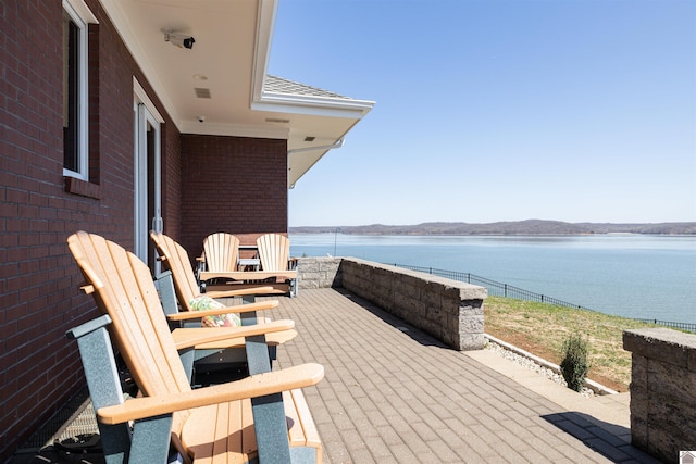 wooden terrace featuring a water view