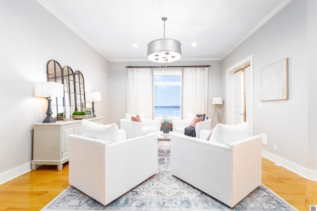 living room with ornamental molding and light hardwood / wood-style floors