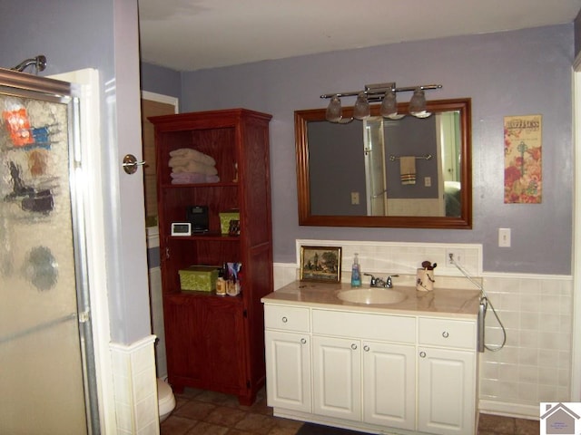 bathroom featuring toilet, tile floors, and large vanity