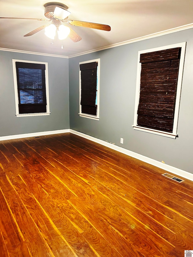 spare room featuring hardwood / wood-style floors, ceiling fan, and ornamental molding