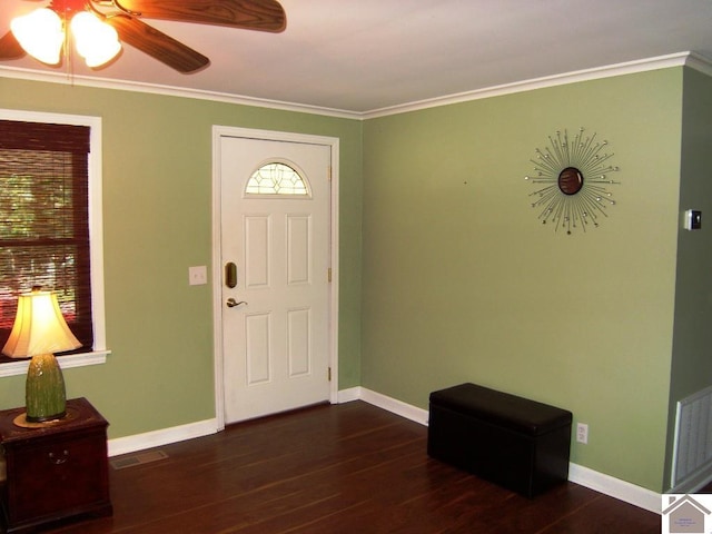 foyer with ceiling fan, ornamental molding, and dark wood-type flooring