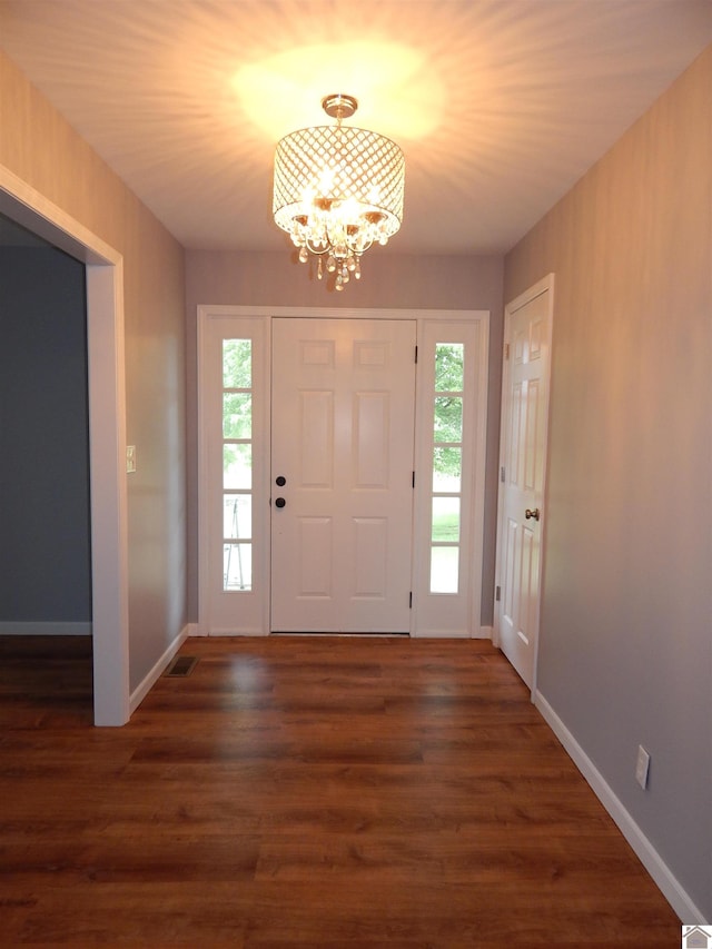 entryway featuring a chandelier and dark hardwood / wood-style flooring