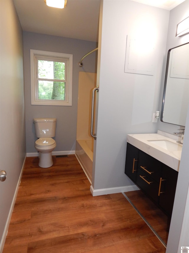 full bathroom with bathing tub / shower combination, hardwood / wood-style floors, toilet, and large vanity