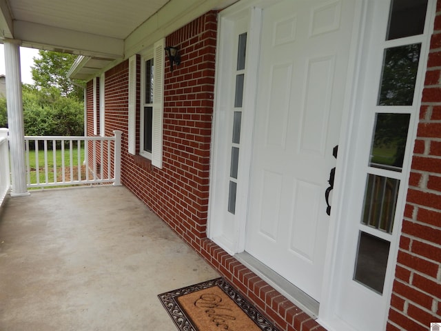 view of exterior entry with covered porch