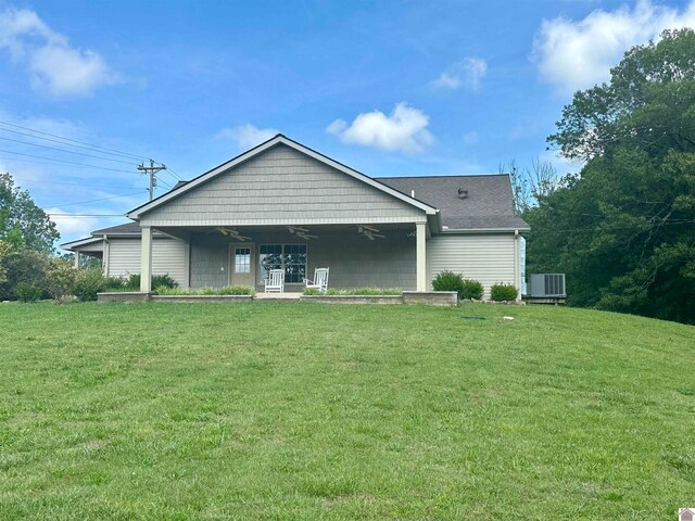 back of property featuring a lawn