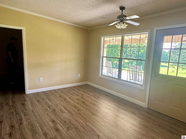 interior space with ceiling fan, a textured ceiling, ornamental molding, and wood-type flooring