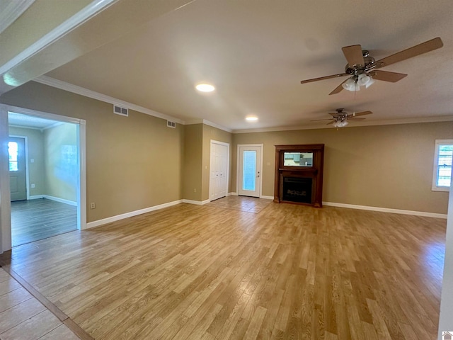 unfurnished living room featuring ceiling fan, crown molding, and light wood-type flooring