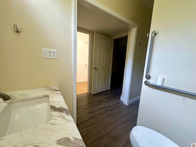 bedroom with sink and dark hardwood / wood-style floors