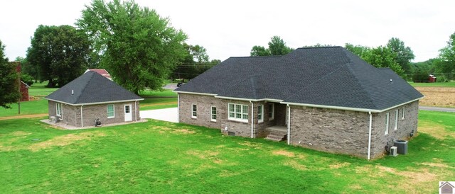 rear view of house with a yard