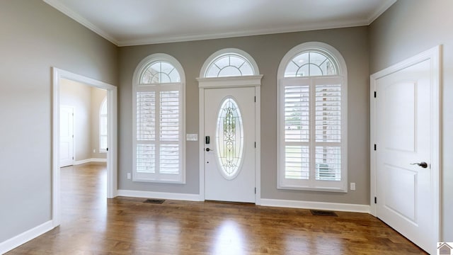 foyer entrance with hardwood / wood-style flooring and crown molding