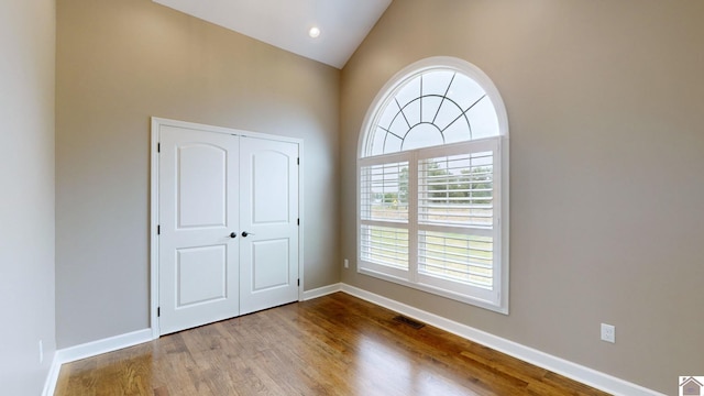 empty room featuring vaulted ceiling and hardwood / wood-style floors