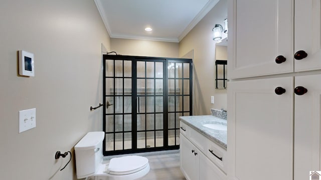 bathroom featuring ornamental molding, toilet, and vanity