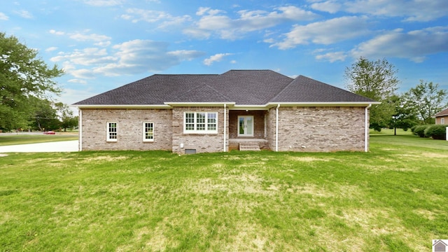 rear view of house with a yard