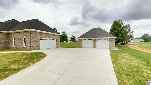 view of home's exterior with a garage and a yard