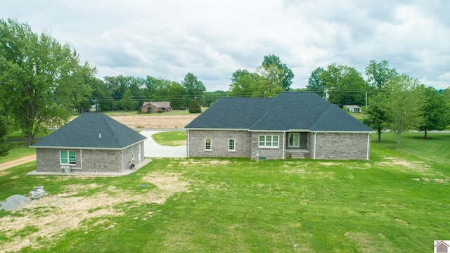 rear view of house featuring a yard