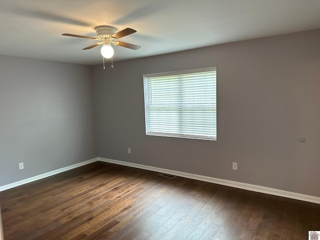 empty room featuring ceiling fan and dark hardwood / wood-style floors