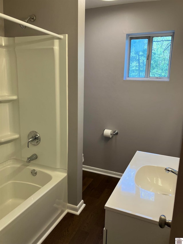 bathroom featuring shower / bath combination, hardwood / wood-style floors, and vanity